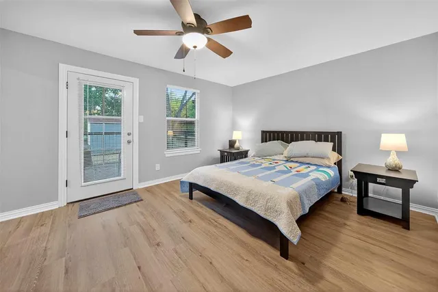 a bedroom with a bed and wooden floor