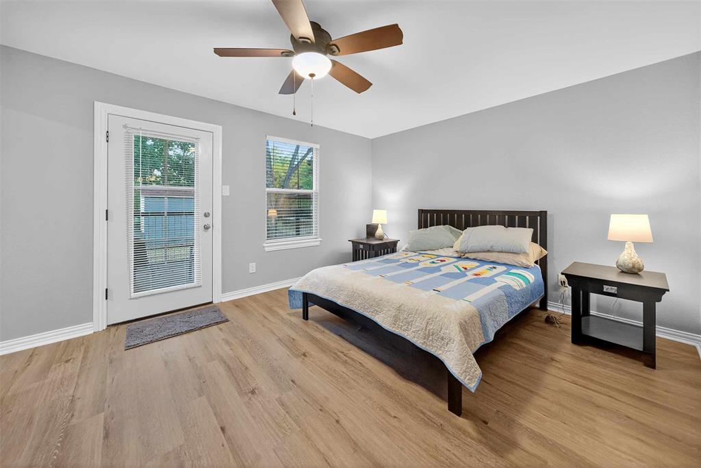 128 Armada Loop Payne Springs, TX 75156 - Photo 18 of 33 a bedroom with a bed and wooden floor