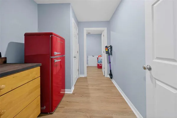 a hallway with a refrigerator