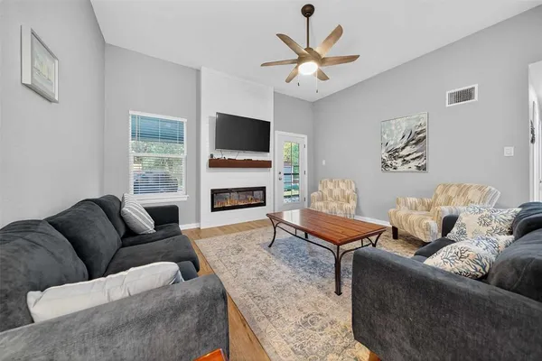a living room with furniture and a flat screen tv