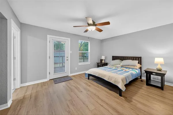 a bedroom with a large bed chandelier and a window