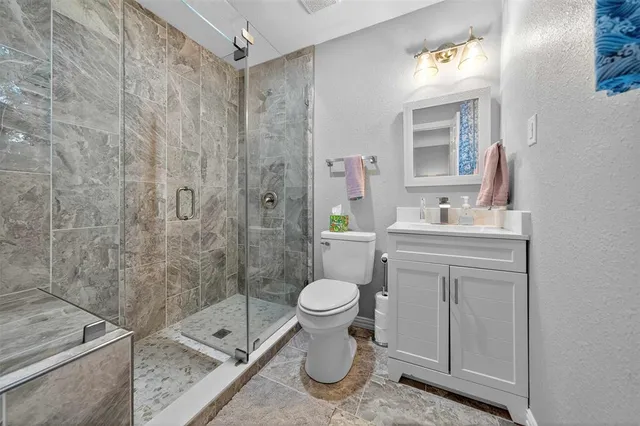 a bathroom with a sink toilet and shower