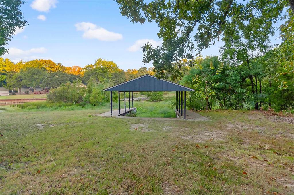 128 Armada Loop Payne Springs, TX 75156 - Photo 10 of 33 a view of a big yard with plants and trees