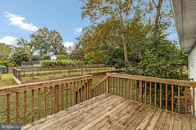 a view of balcony with wooden floor and fence