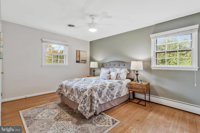 a bedroom with a bed lamp and a window