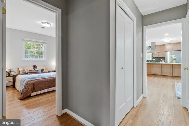 a bedroom with a bed and a view of kitchen