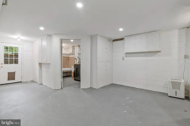 a view of an empty room with a kitchen