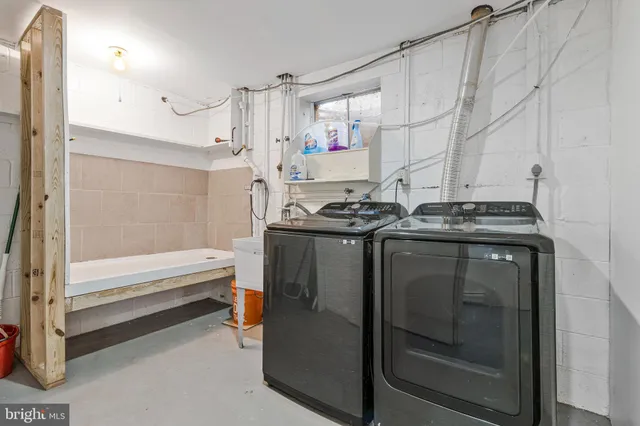 a utility room with stainless steel appliances wooden floor and view living room