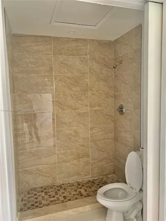 a bathroom with a toilet and a shower