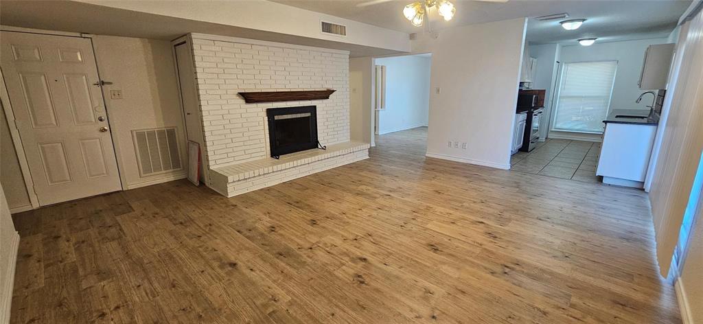 1900 Apple Valley Road Plano, TX 75023 - Photo 17 of 32 a view of empty room with wooden floor and fireplace