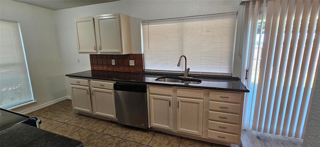 1900 Apple Valley Road Plano, TX 75023 - Photo 18 of 32 a kitchen with a sink and cabinets