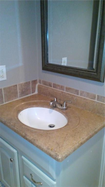 1900 Apple Valley Road Plano, TX 75023 - Photo 22 of 32 a bathroom with a sink and a mirror