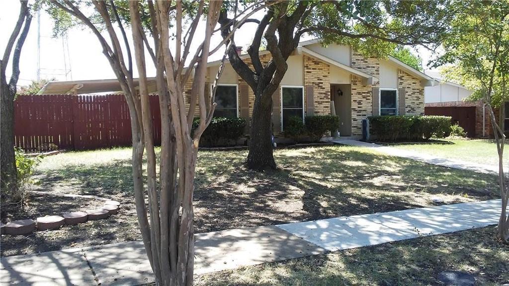 1900 Apple Valley Road Plano, TX 75023 - Photo 5 of 32 a front view of a house with a yard covered in snow