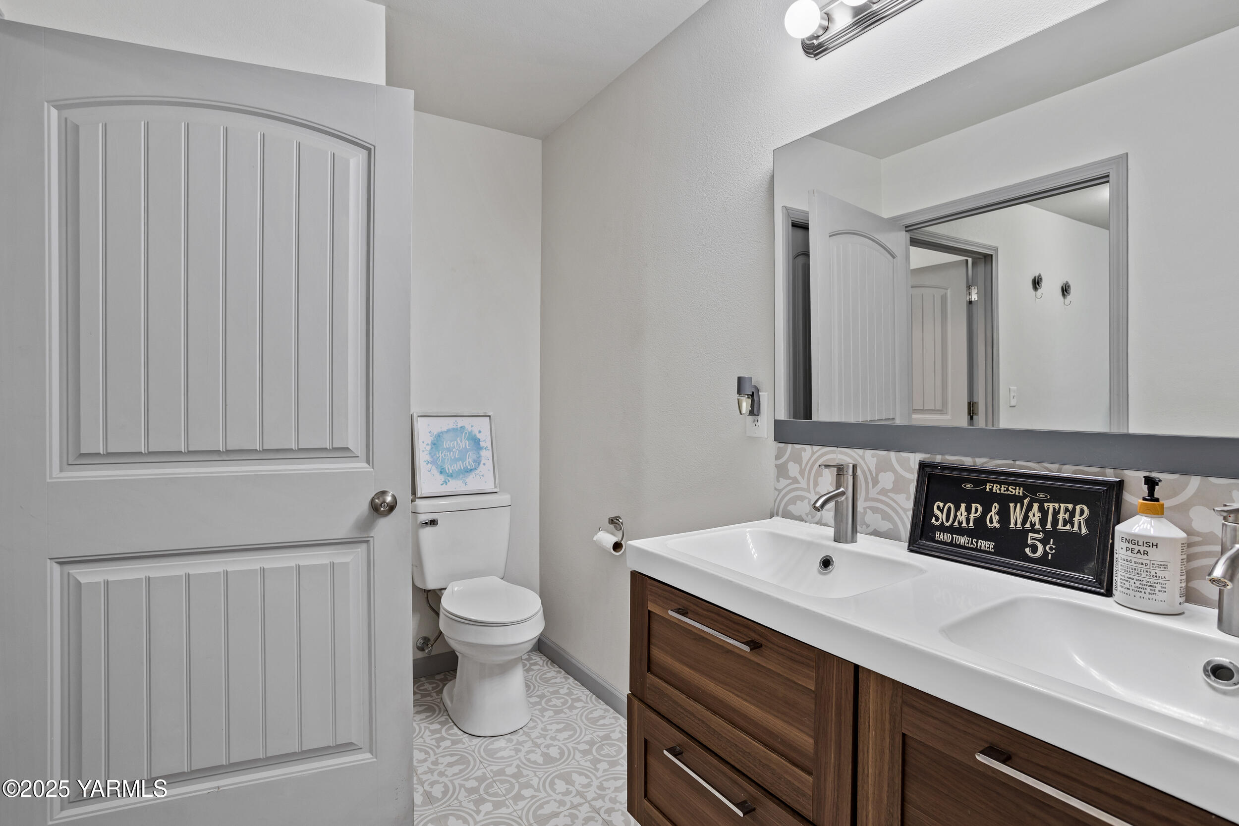 3485 Selah Loop Road Selah, WA 98942 - Photo 15 of 38 a bathroom with a sink a toilet and a mirror