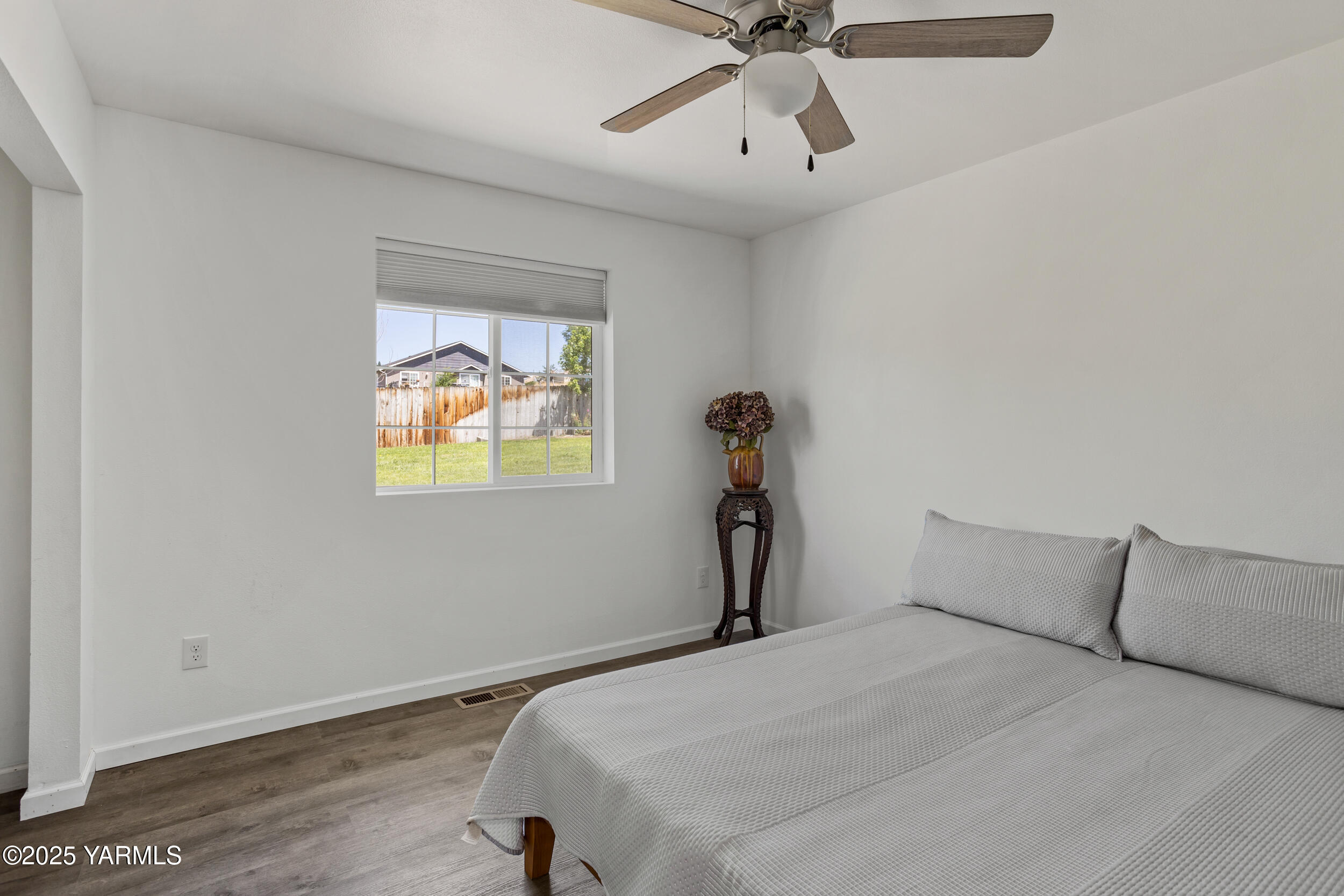 3485 Selah Loop Road Selah, WA 98942 - Photo 16 of 38 a bedroom with a bed and a chandelier