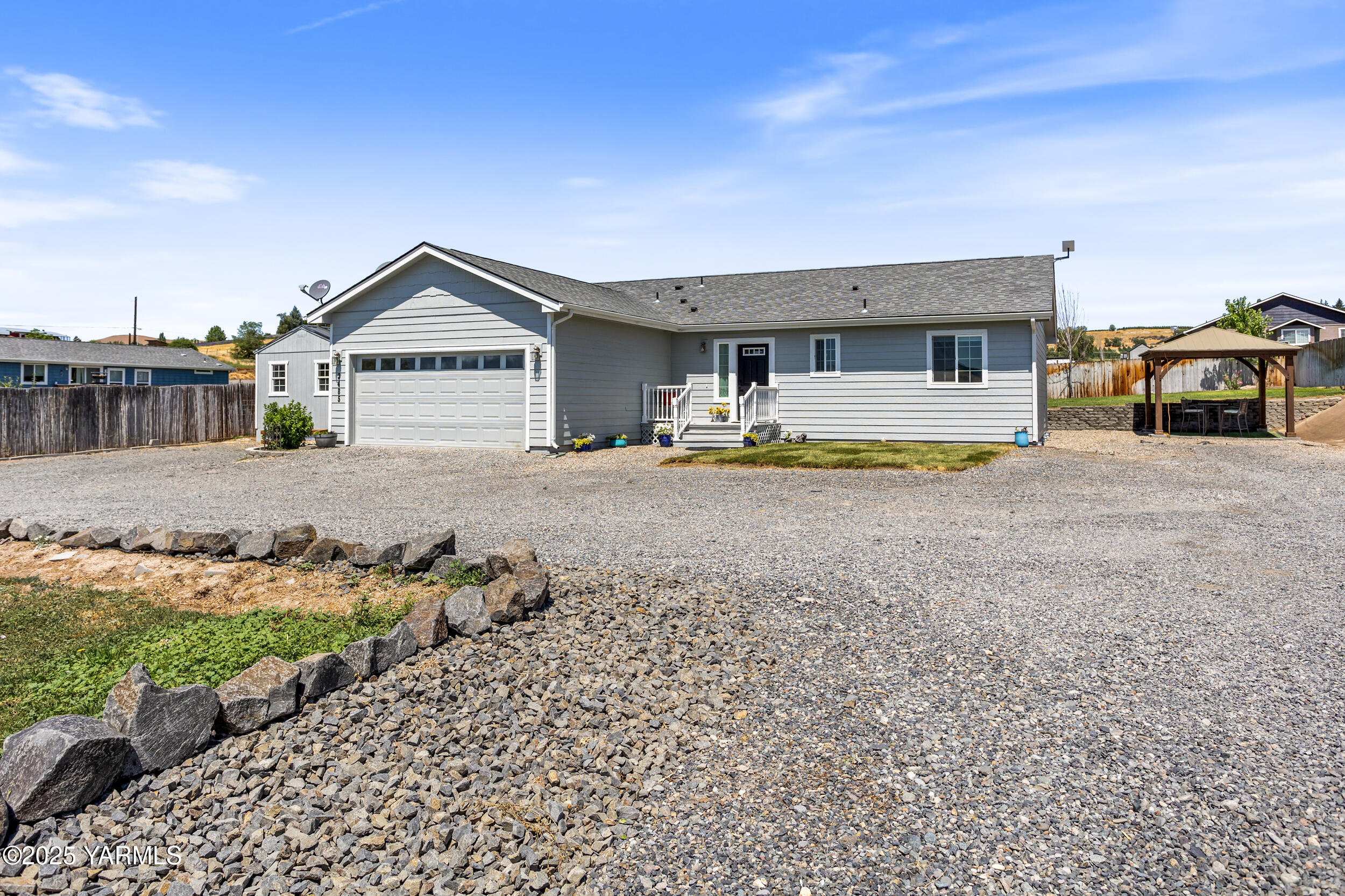 3485 Selah Loop Road Selah, WA 98942 - Photo 36 of 38 a front view of a house with a yard and garage