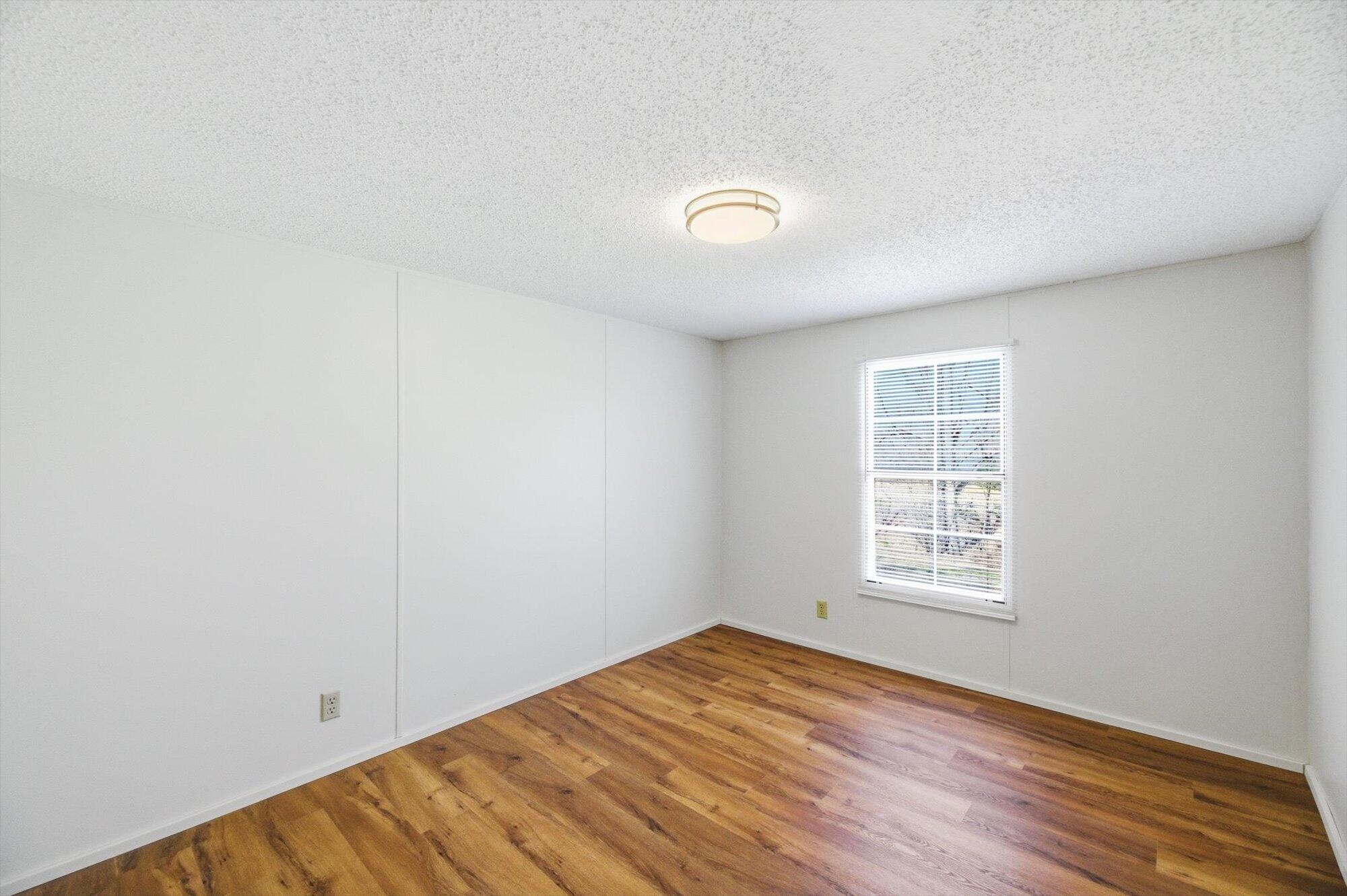64 County Road 100 Decatur, TN 37322 - Photo 18 of 43 an empty room with wooden floor and windows