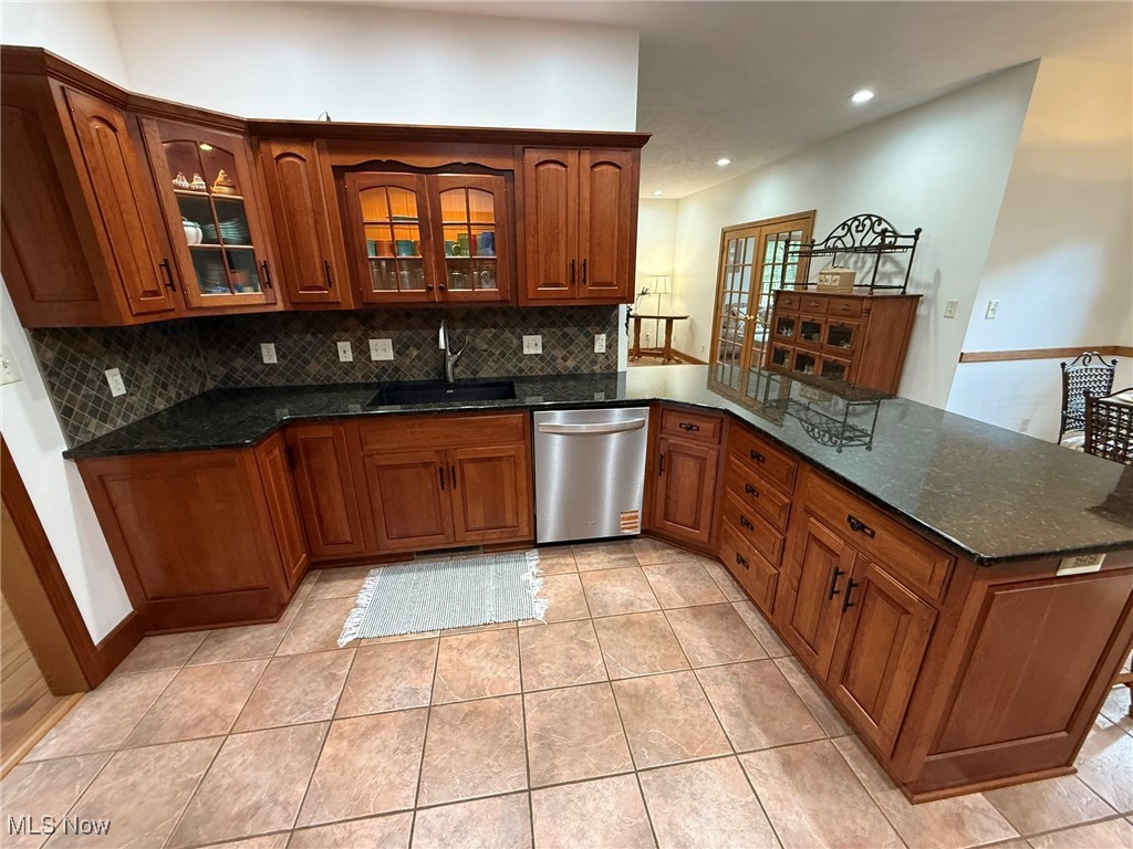 2178 Pleasant Valley Road Northeast New Philadelphia, OH 44663 - Photo 7 of 50 Kitchen featuring glass insert cabinets, dark stone counters, brown cabinets, dishwasher, and recessed lighting