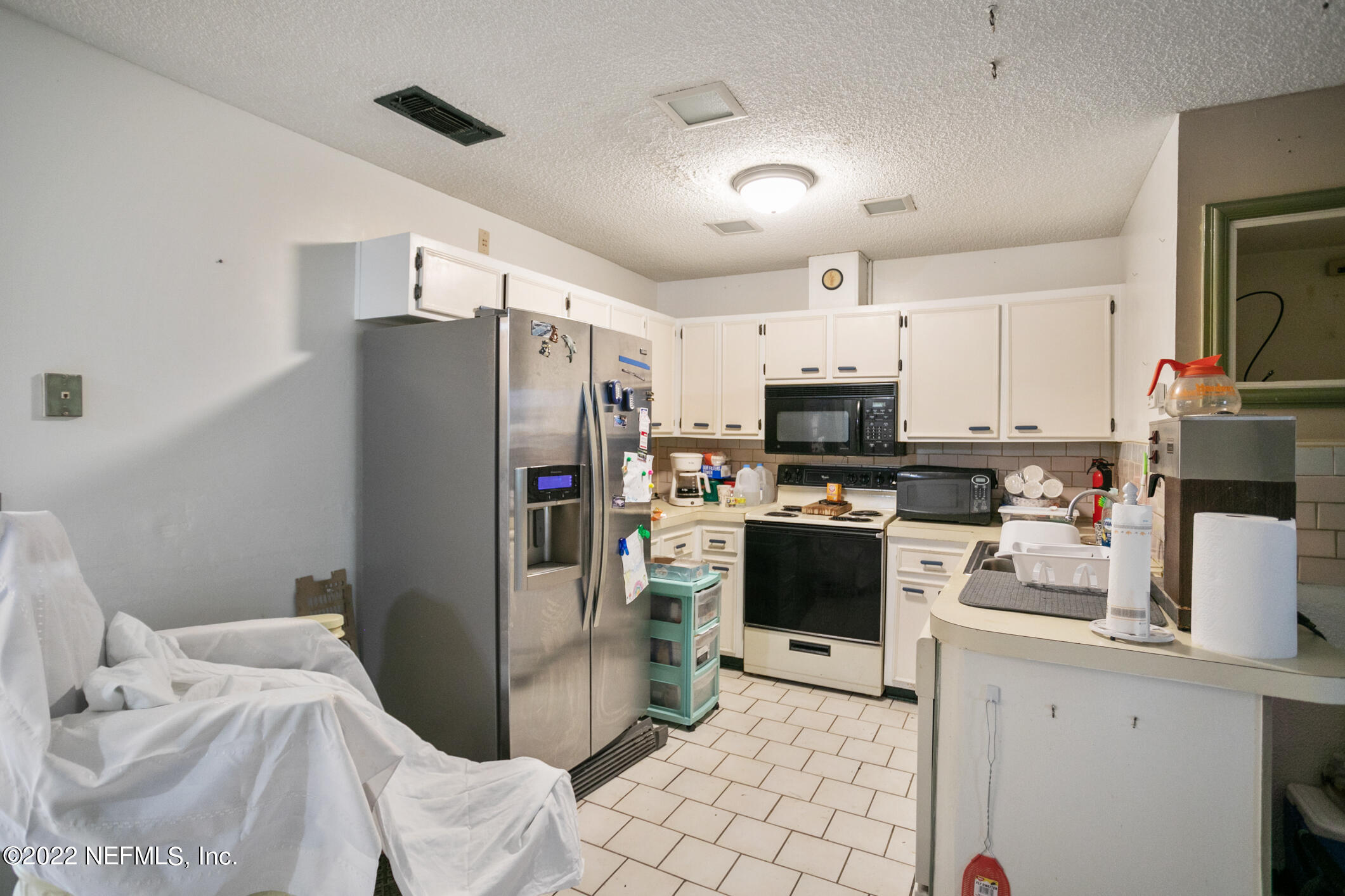 3150 Ricky Drive Jacksonville, FL 32223 - Photo 15 of 28 a kitchen with stainless steel appliances a refrigerator sink and microwave