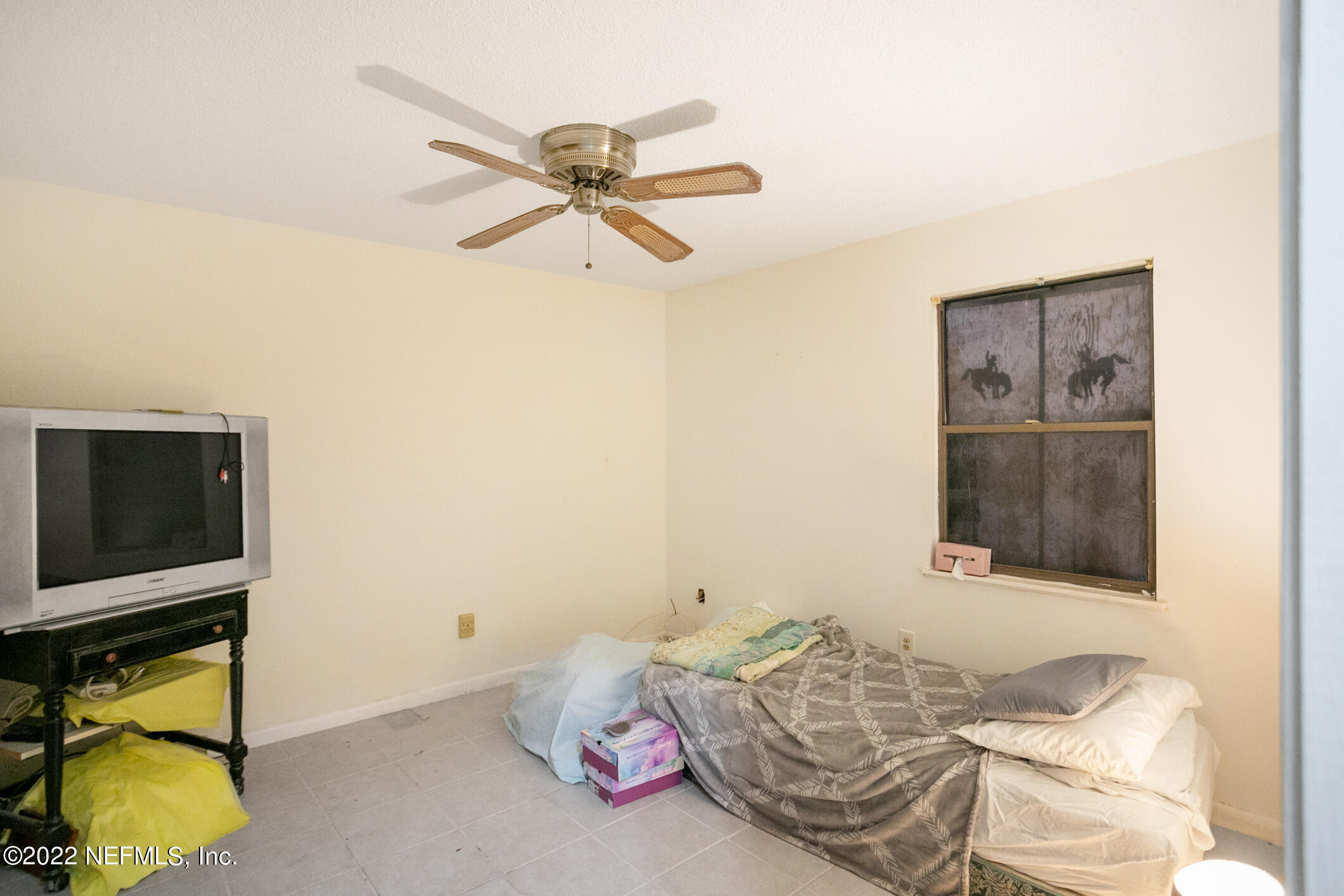 3150 Ricky Drive Jacksonville, FL 32223 - Photo 17 of 28 a bedroom with a bed and a flat screen tv