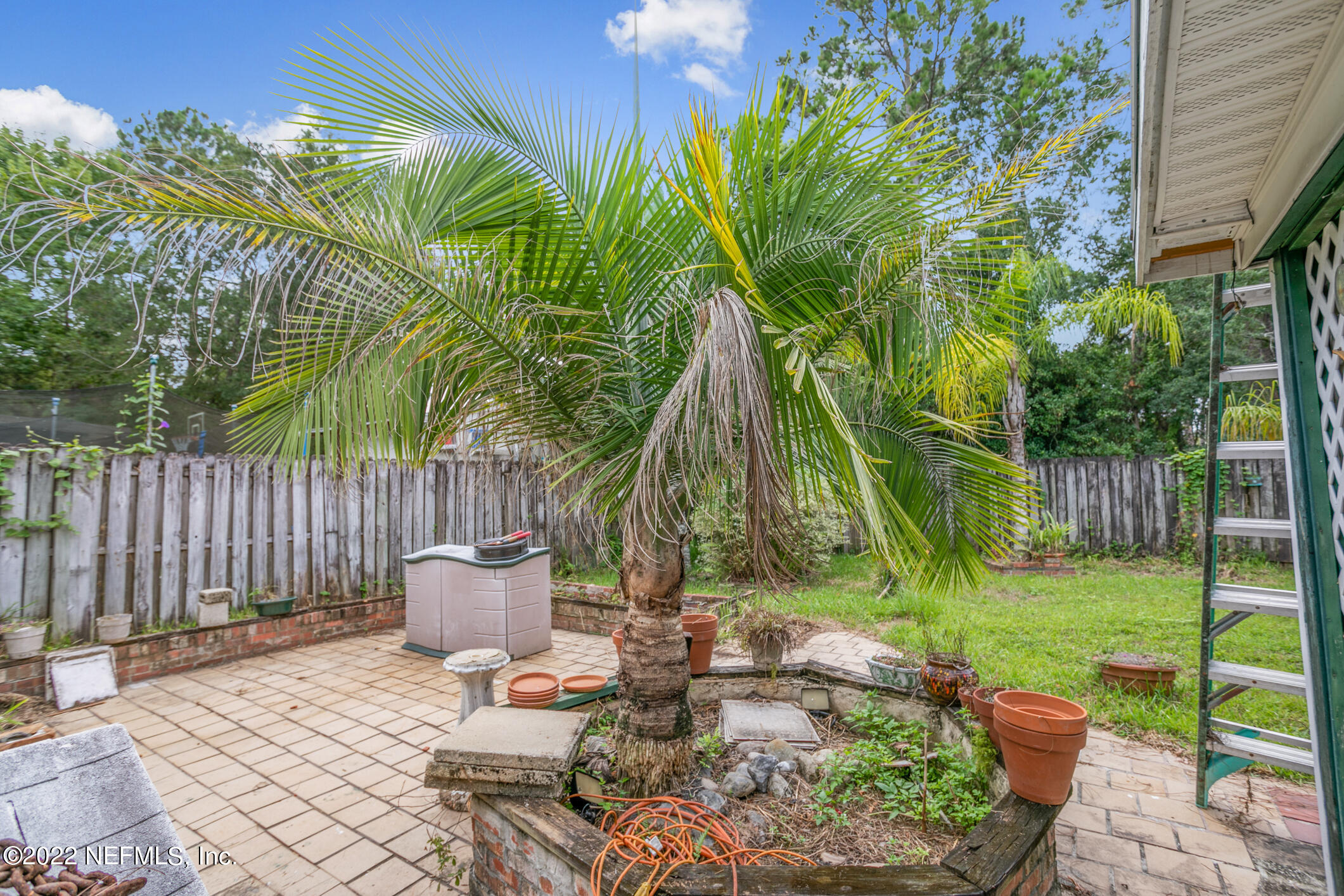 3150 Ricky Drive Jacksonville, FL 32223 - Photo 26 of 28 a view of a chair and table in the backyard