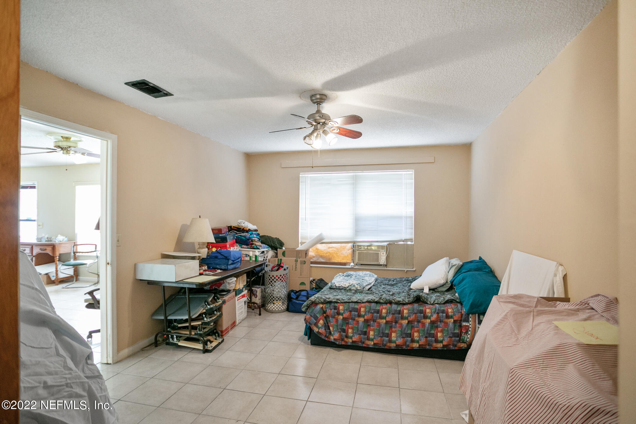 3150 Ricky Drive Jacksonville, FL 32223 - Photo 8 of 28 a bedroom with bed and a chandelier