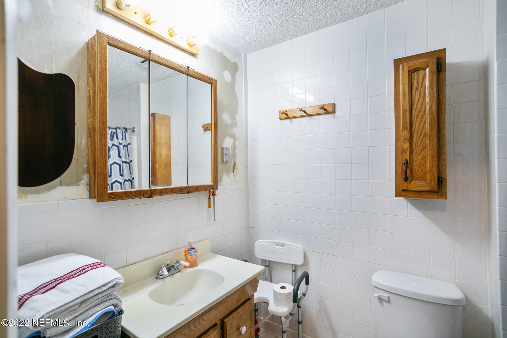 3150 Ricky Drive Jacksonville, FL 32223 - Photo 10 of 28 a bathroom with a sink a mirror and a toilet