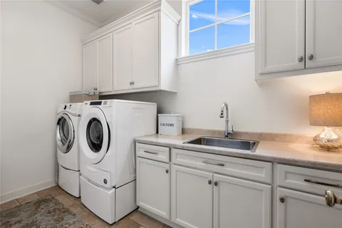 a utility room with sink dryer and washer