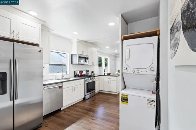 a kitchen with a refrigerator a sink and cabinets