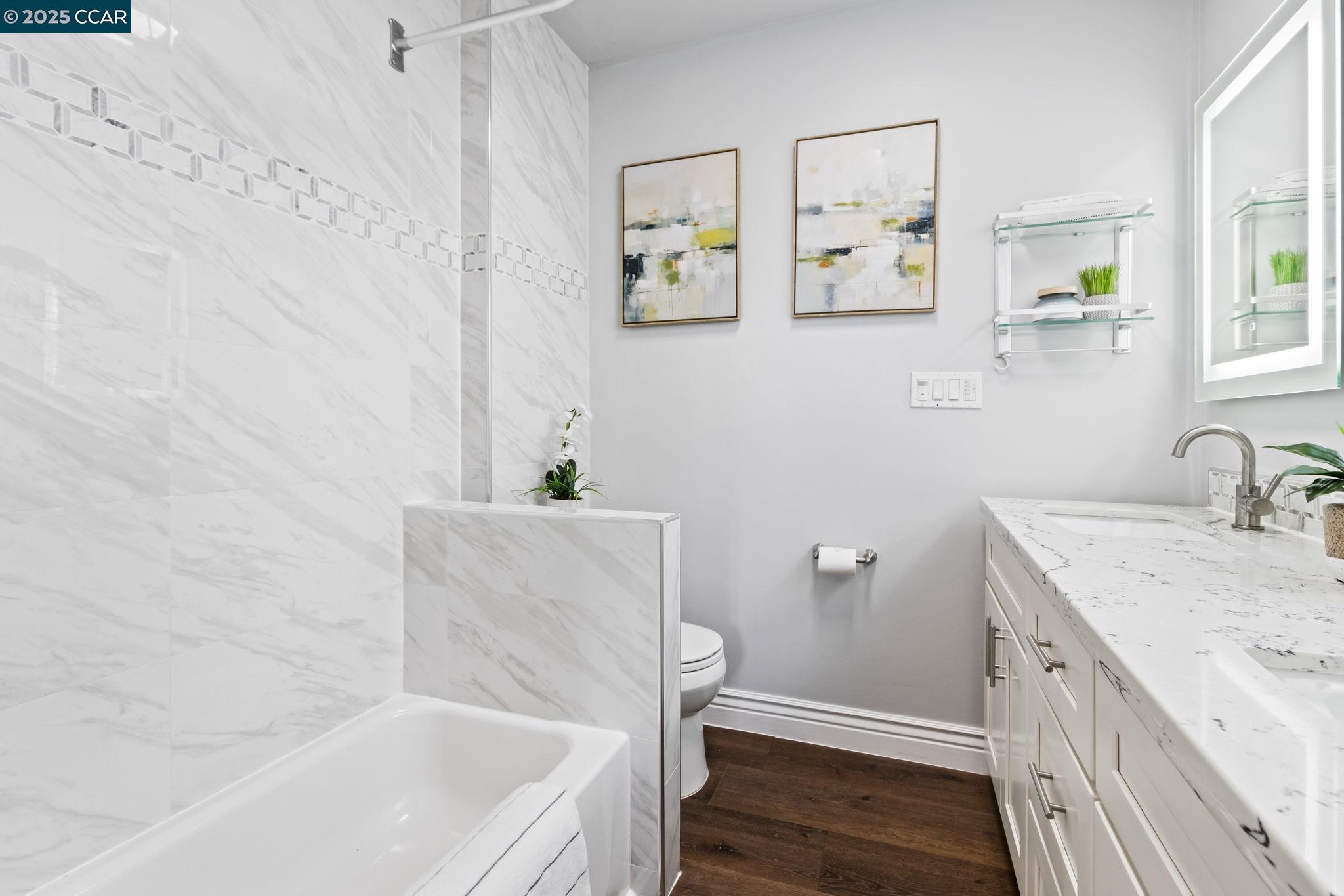 4010 Masterson Street Oakland, CA 94619 - Photo 14 of 27 a bathroom with a tub sink and mirror
