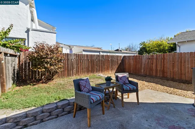 a backyard of a house with table and chairs