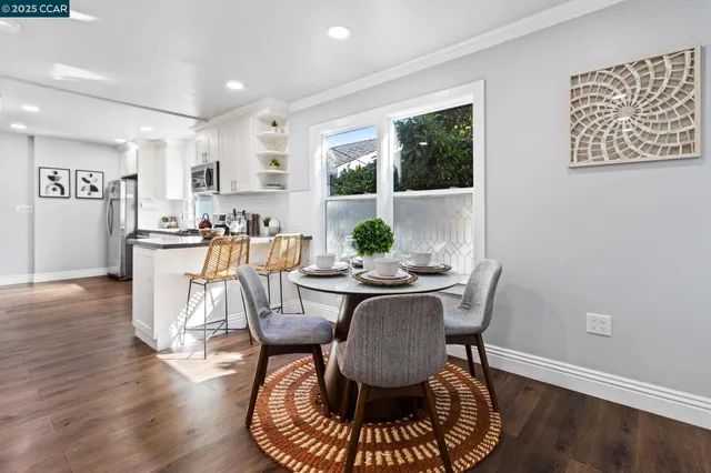 a view of a dining room with furniture window and wooden floor