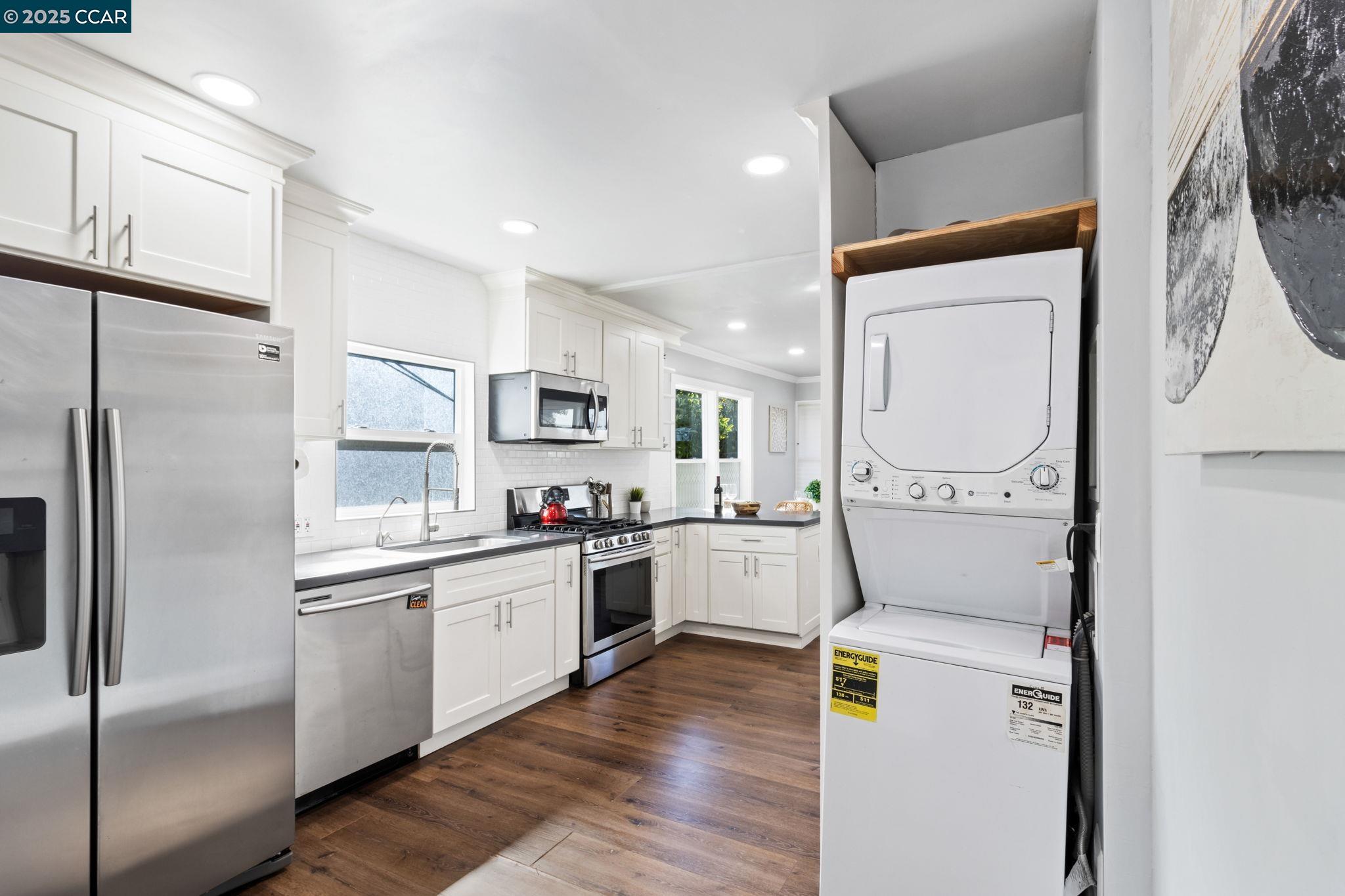 4010 Masterson Street Oakland, CA 94619 - Photo 10 of 27 a kitchen with a refrigerator a sink and cabinets