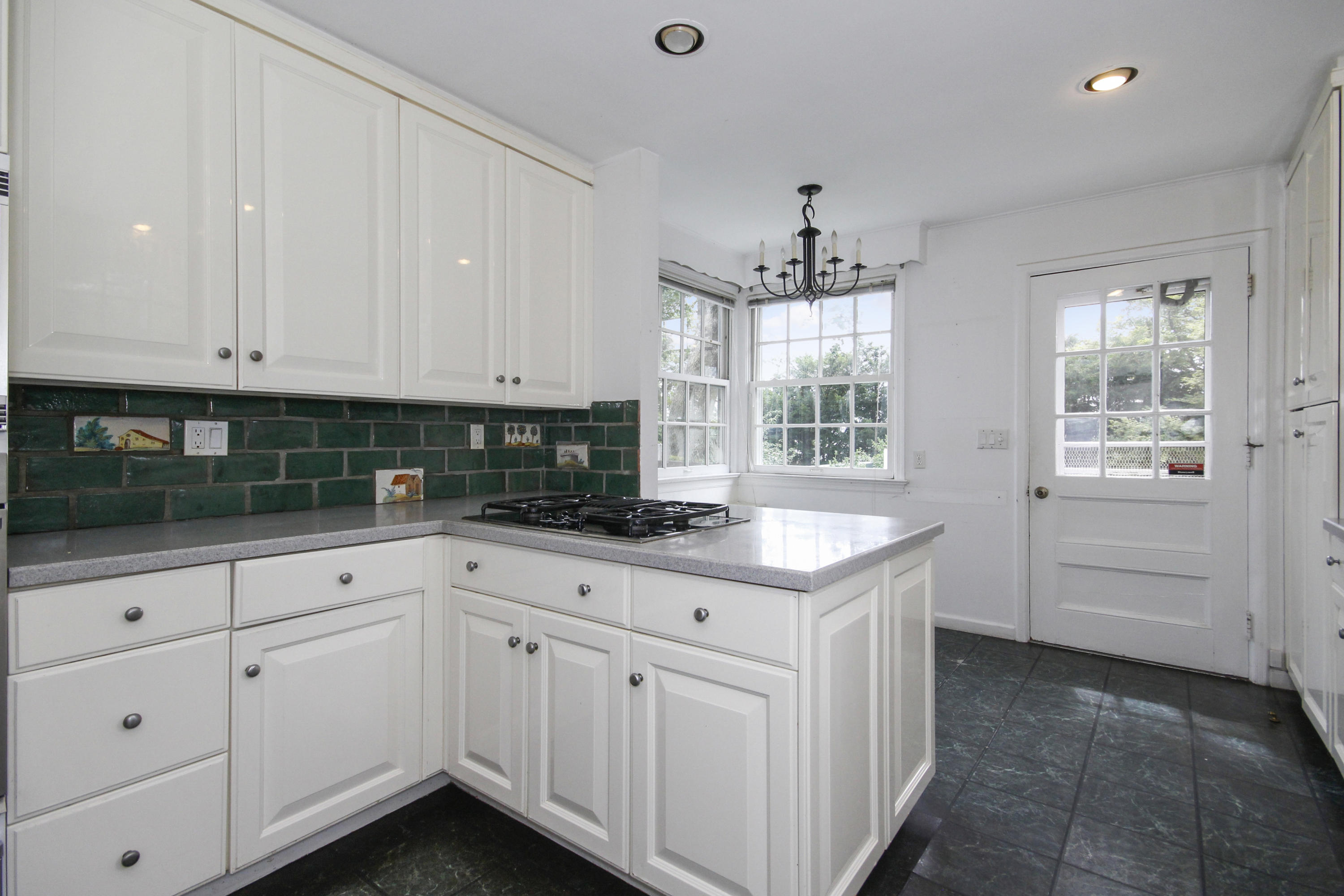 237 Long Neck Point Road Darien, CT 06820 - Photo 12 of 38 a kitchen with granite countertop white cabinets and white appliances