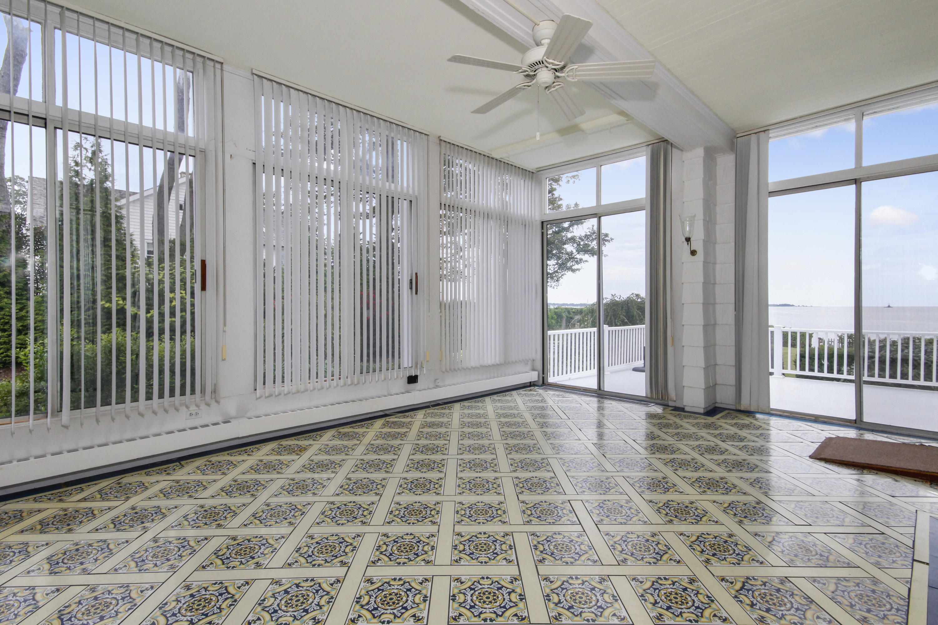 237 Long Neck Point Road Darien, CT 06820 - Photo 13 of 38 a view of a bedroom with wooden floor and balcony