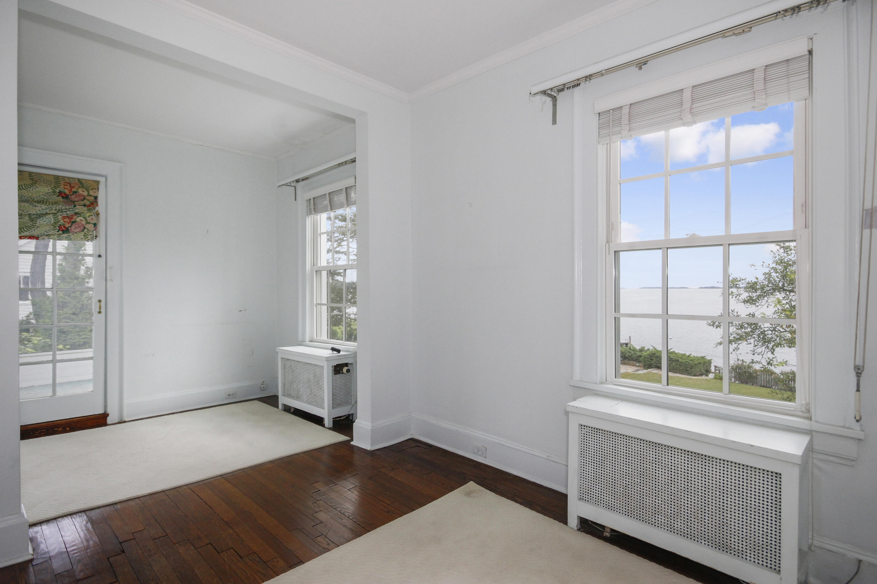 237 Long Neck Point Road Darien, CT 06820 - Photo 17 of 38 a view of empty room with wooden floor and fan