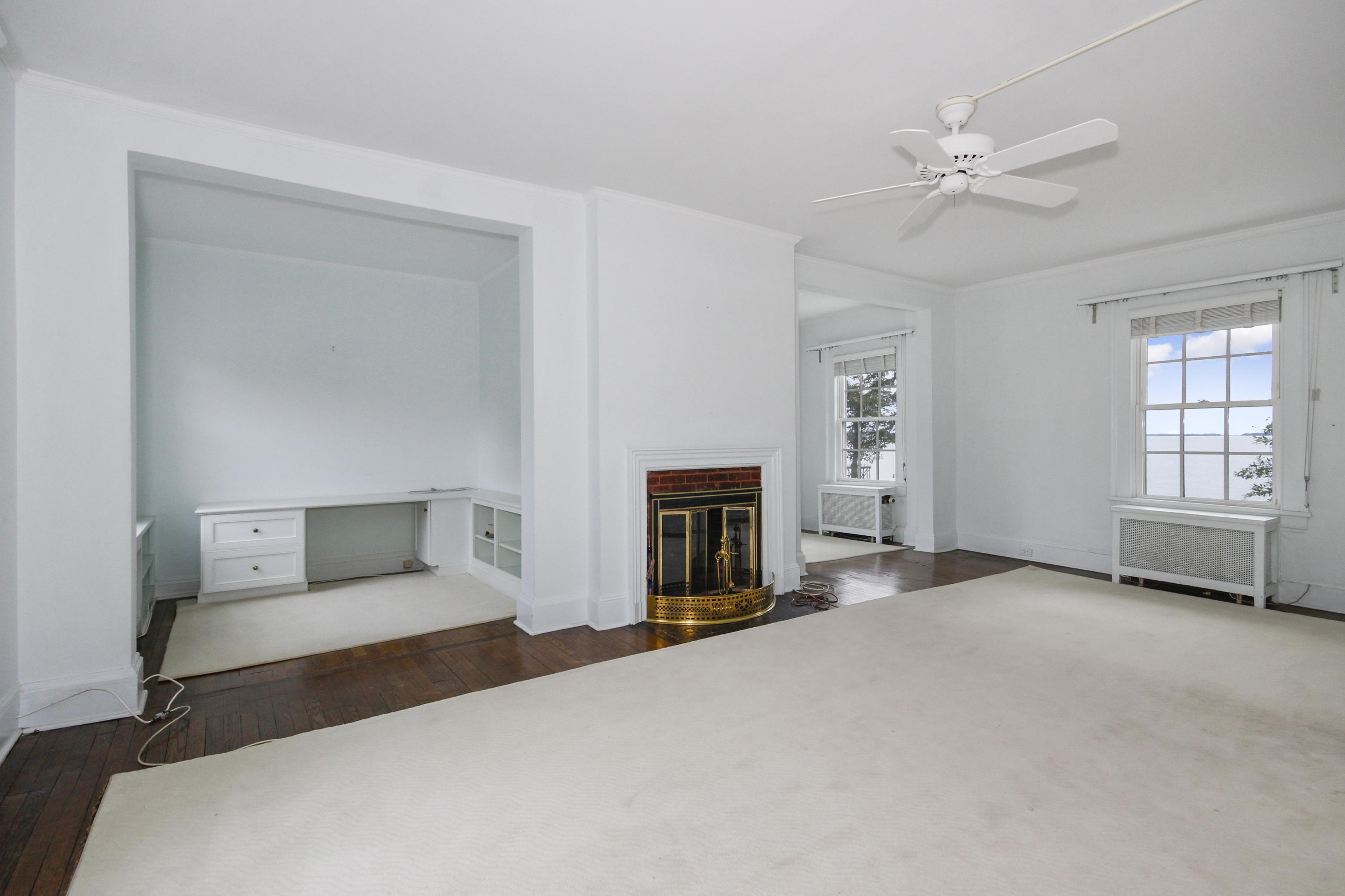 237 Long Neck Point Road Darien, CT 06820 - Photo 18 of 38 a living room with furniture and a fireplace