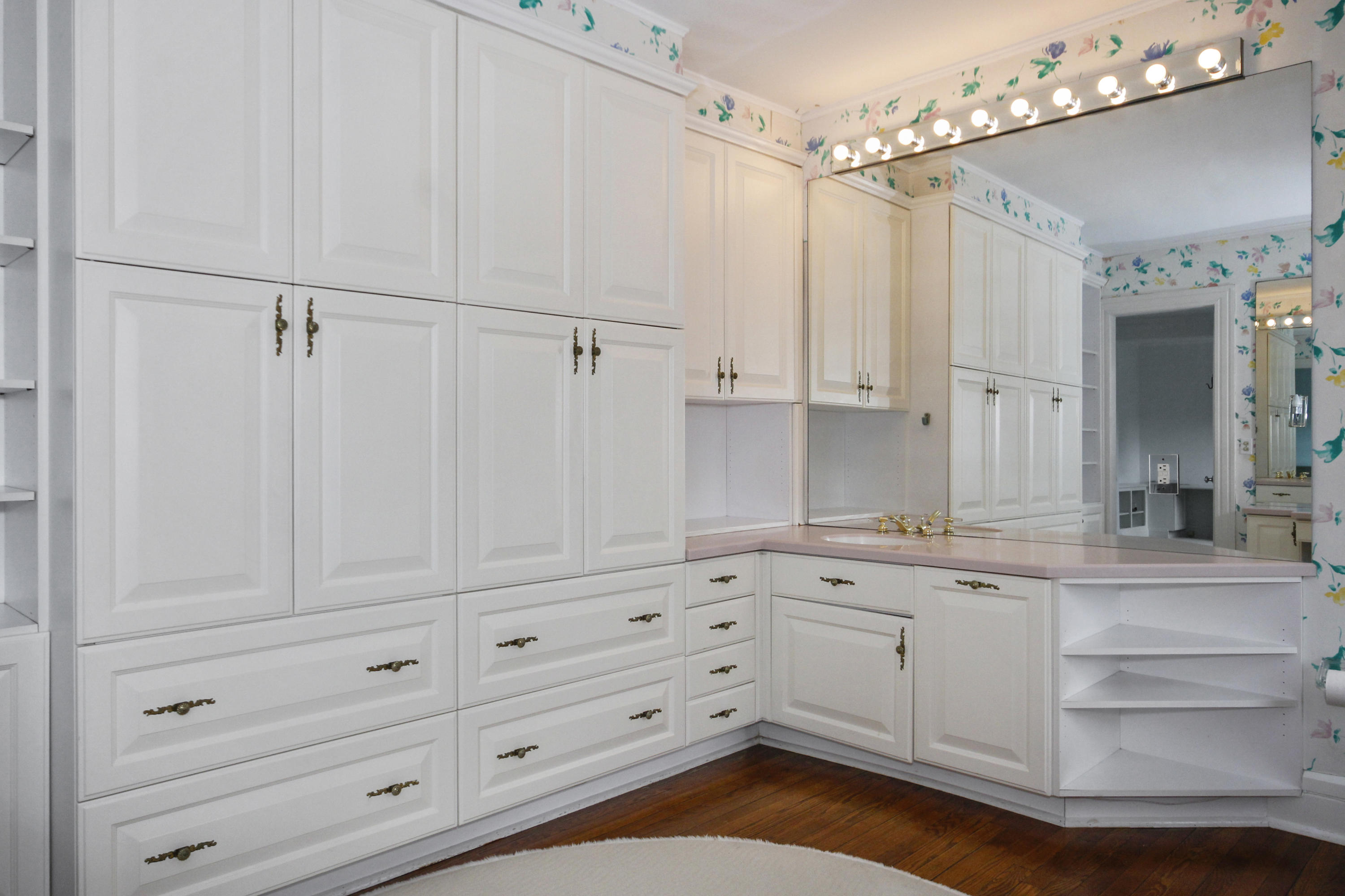 237 Long Neck Point Road Darien, CT 06820 - Photo 20 of 38 a kitchen with white cabinets and chandelier