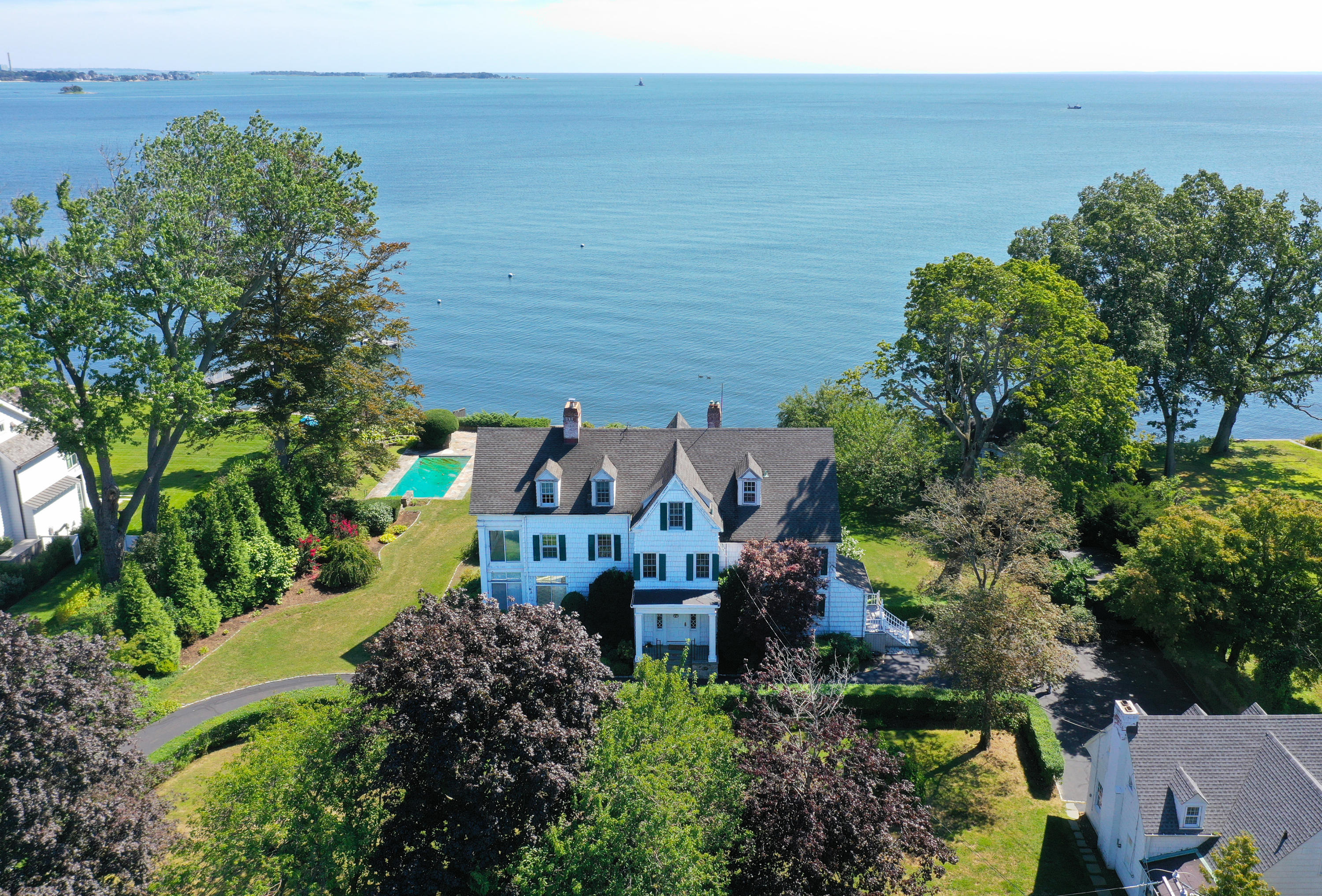 237 Long Neck Point Road Darien, CT 06820 - Photo 2 of 38 a view of a garden with lawn chairs