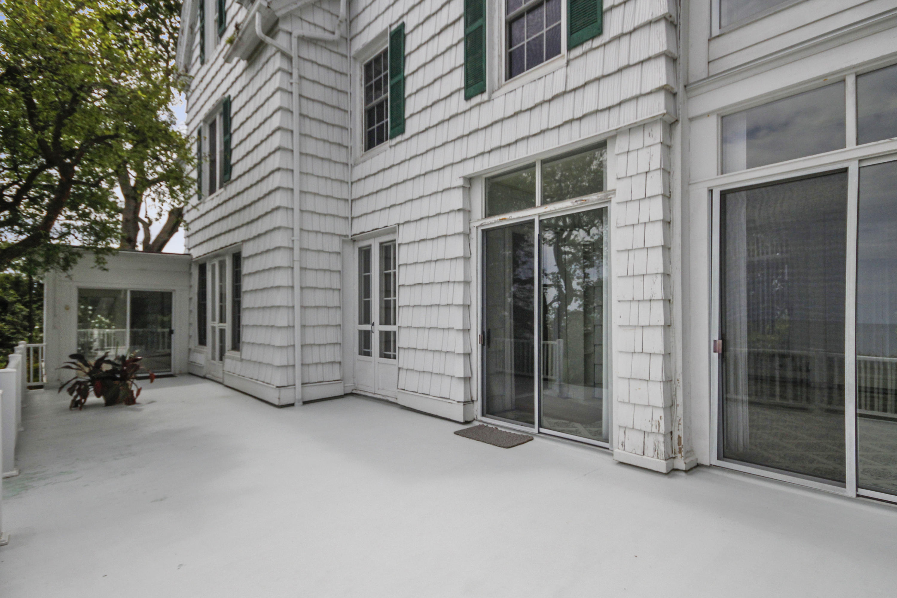 237 Long Neck Point Road Darien, CT 06820 - Photo 23 of 38 a view of a building with glass door and brick wall