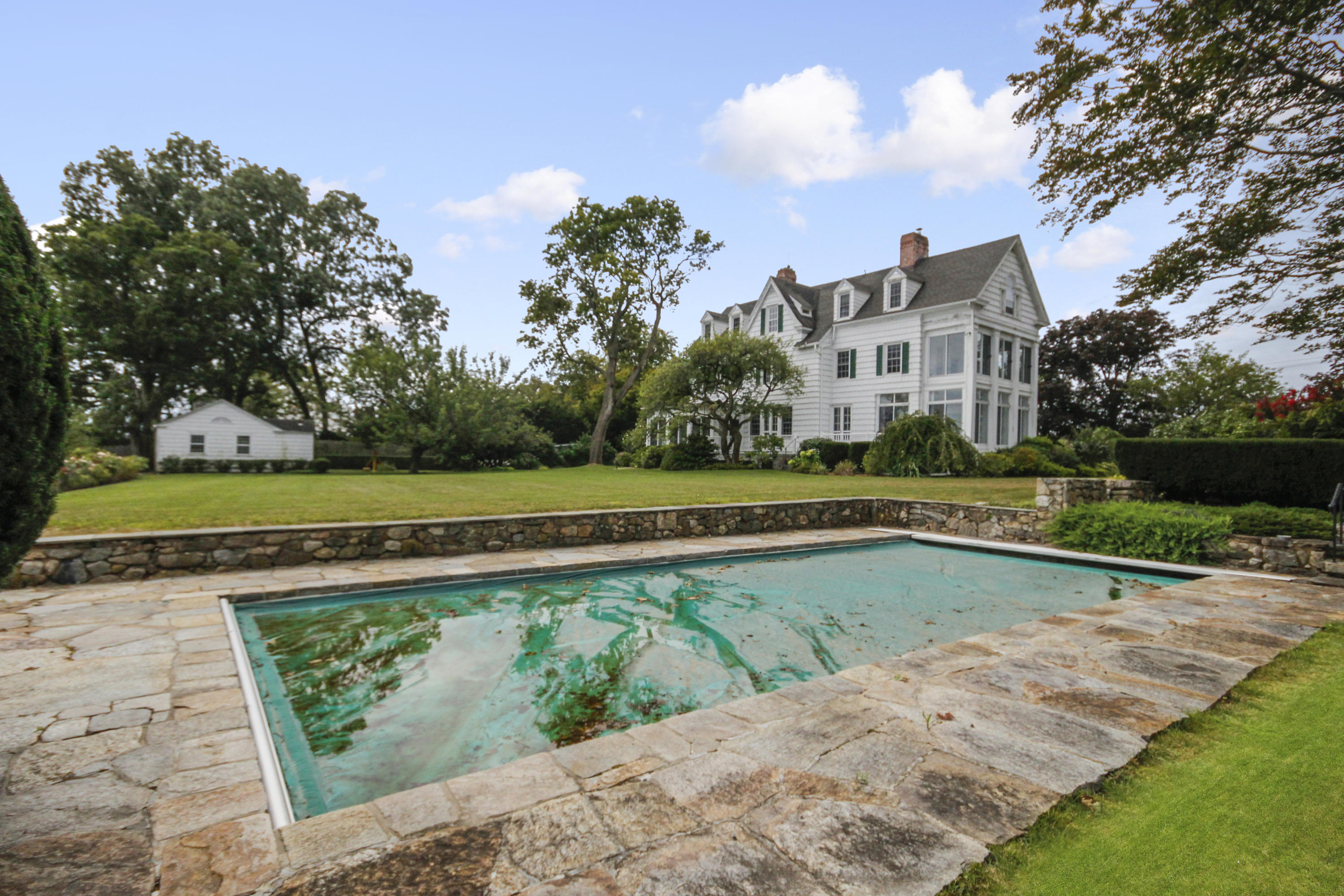 237 Long Neck Point Road Darien, CT 06820 - Photo 26 of 38 a view of swimming pool with a yard and plants