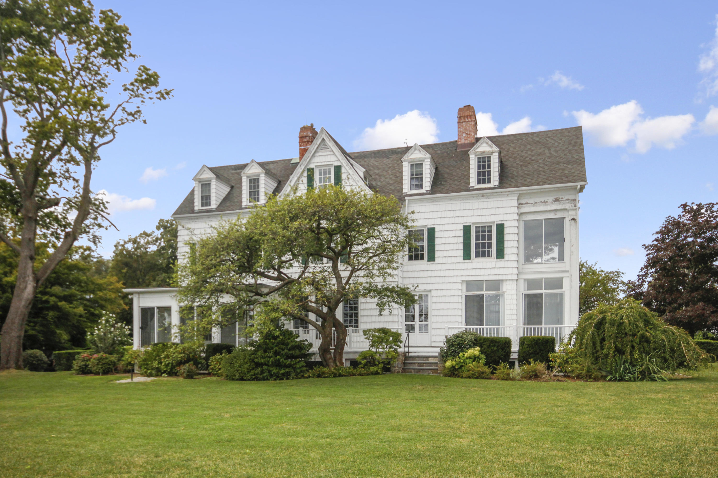 237 Long Neck Point Road Darien, CT 06820 - Photo 27 of 38 a front view of a house with a yard