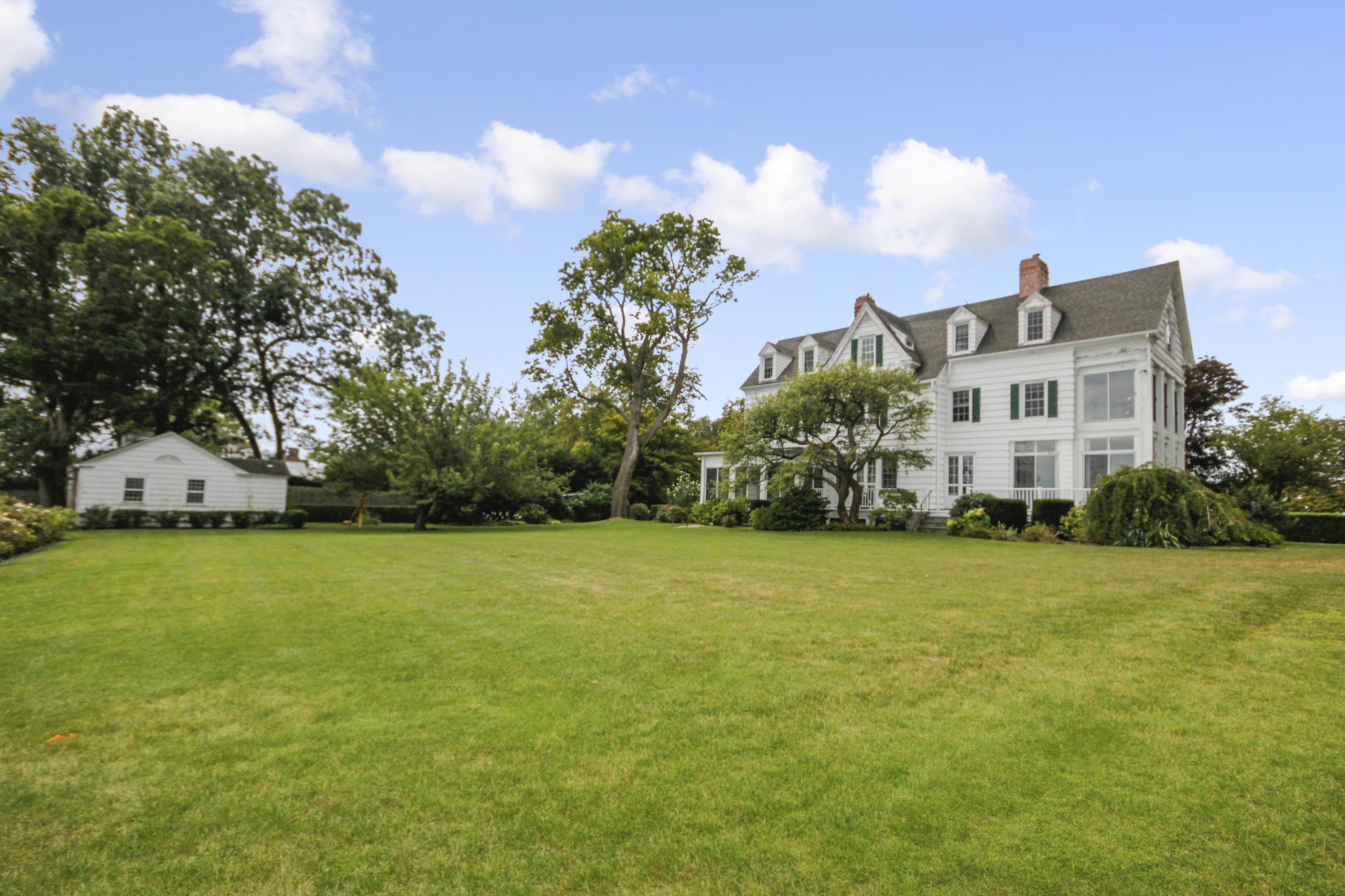 237 Long Neck Point Road Darien, CT 06820 - Photo 28 of 38 a front view of a building with an outdoor space and seating