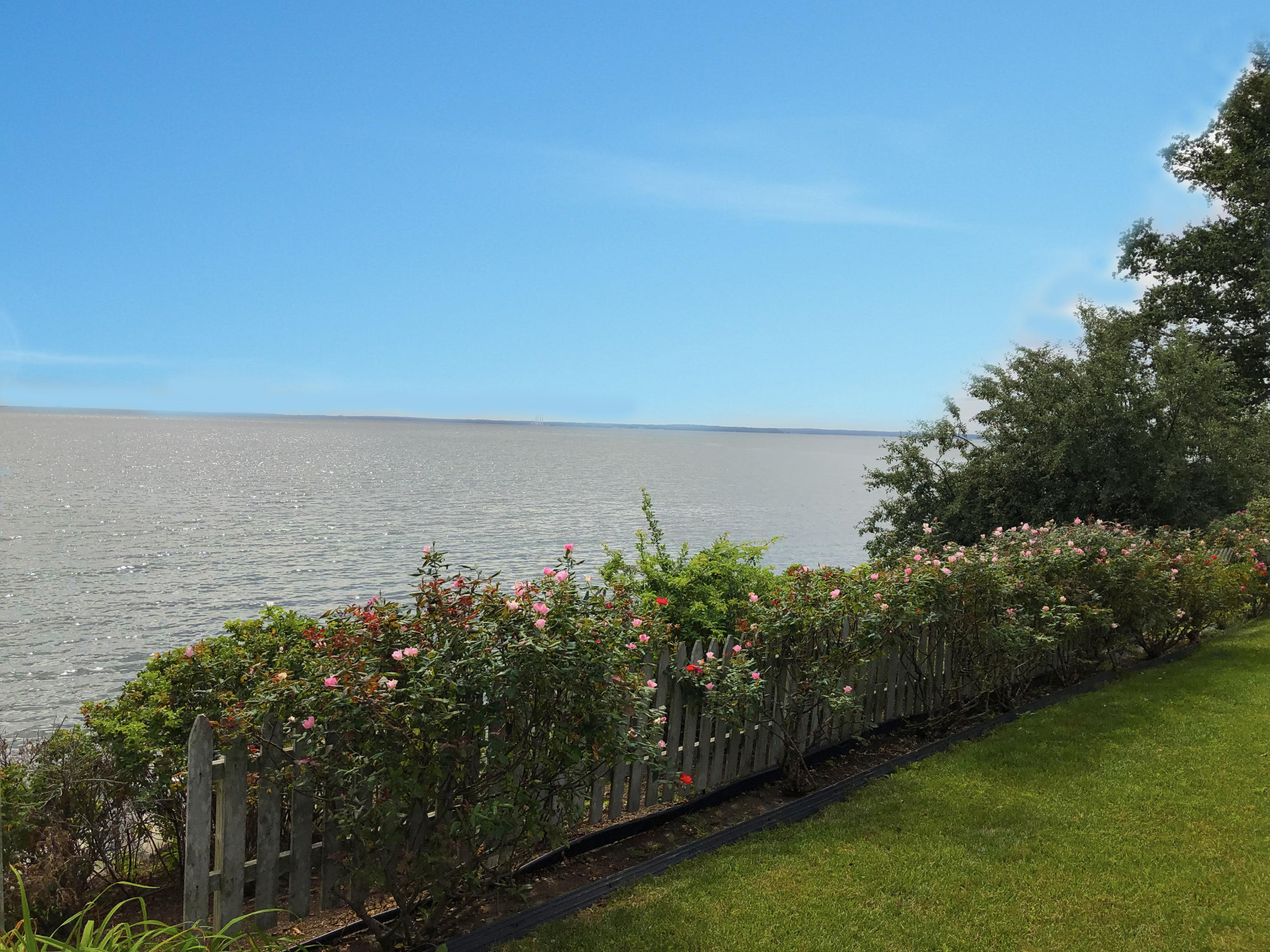 237 Long Neck Point Road Darien, CT 06820 - Photo 33 of 38 a view of a lake with a building in the background