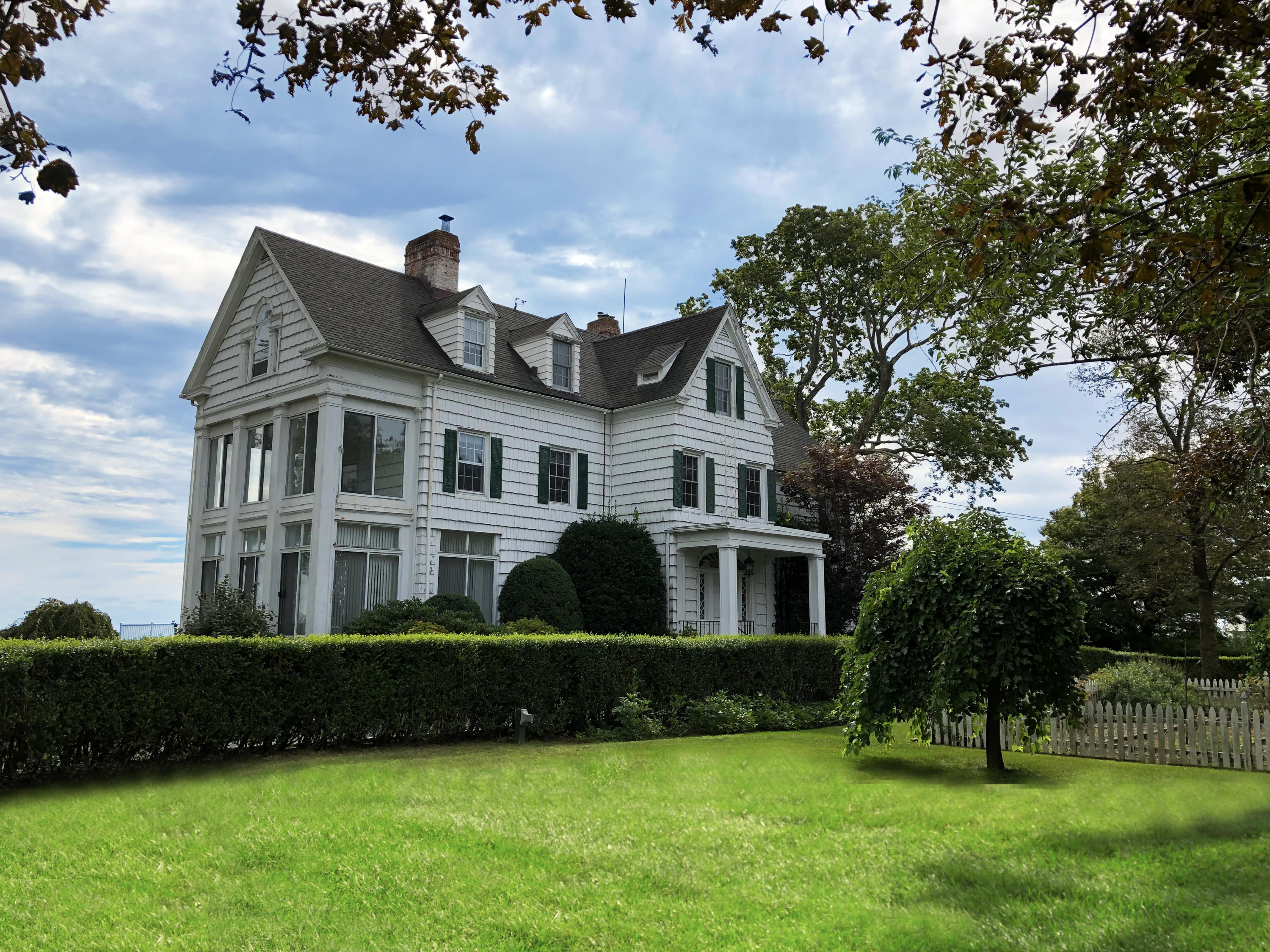 237 Long Neck Point Road Darien, CT 06820 - Photo 34 of 38 a front view of a house with a garden