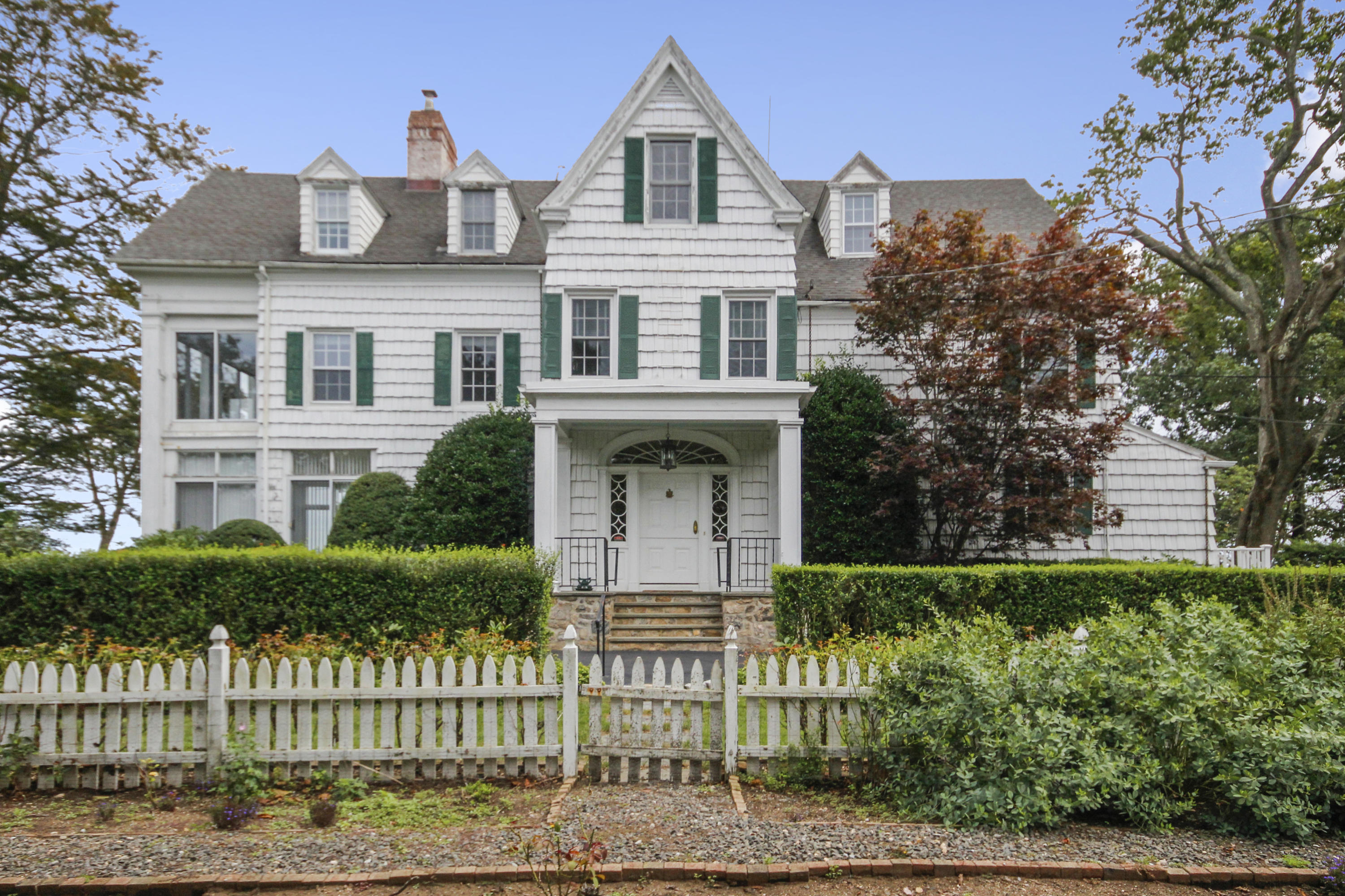237 Long Neck Point Road Darien, CT 06820 - Photo 6 of 38 a front view of a house with a yard