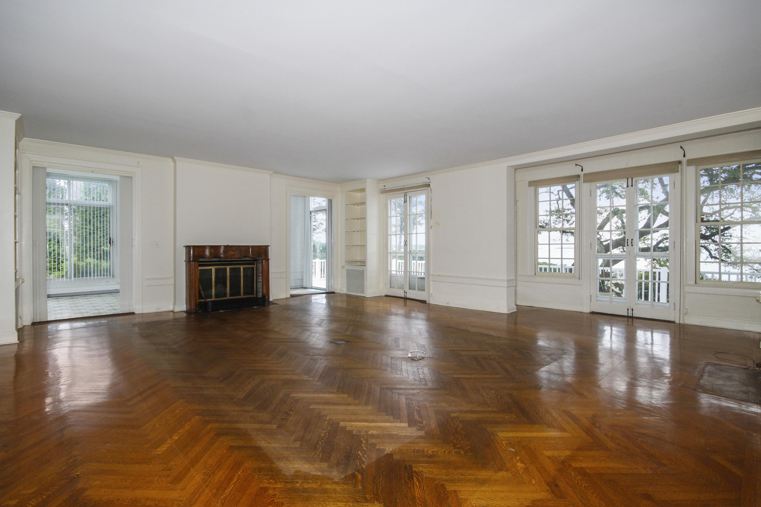 237 Long Neck Point Road Darien, CT 06820 - Photo 7 of 38 a view of empty room with fireplace and wooden floor