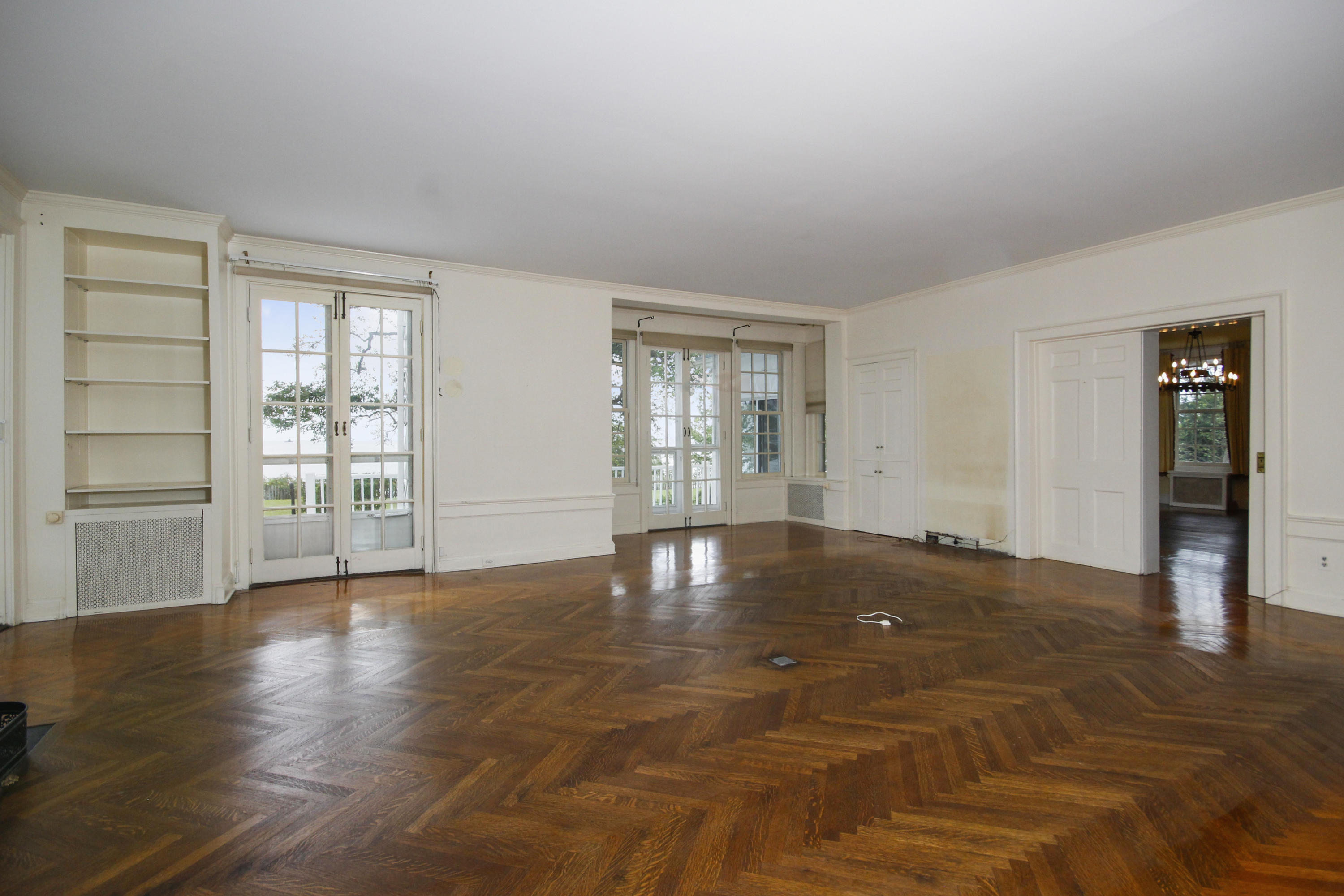 237 Long Neck Point Road Darien, CT 06820 - Photo 8 of 38 a view of empty room with wooden floor and fan