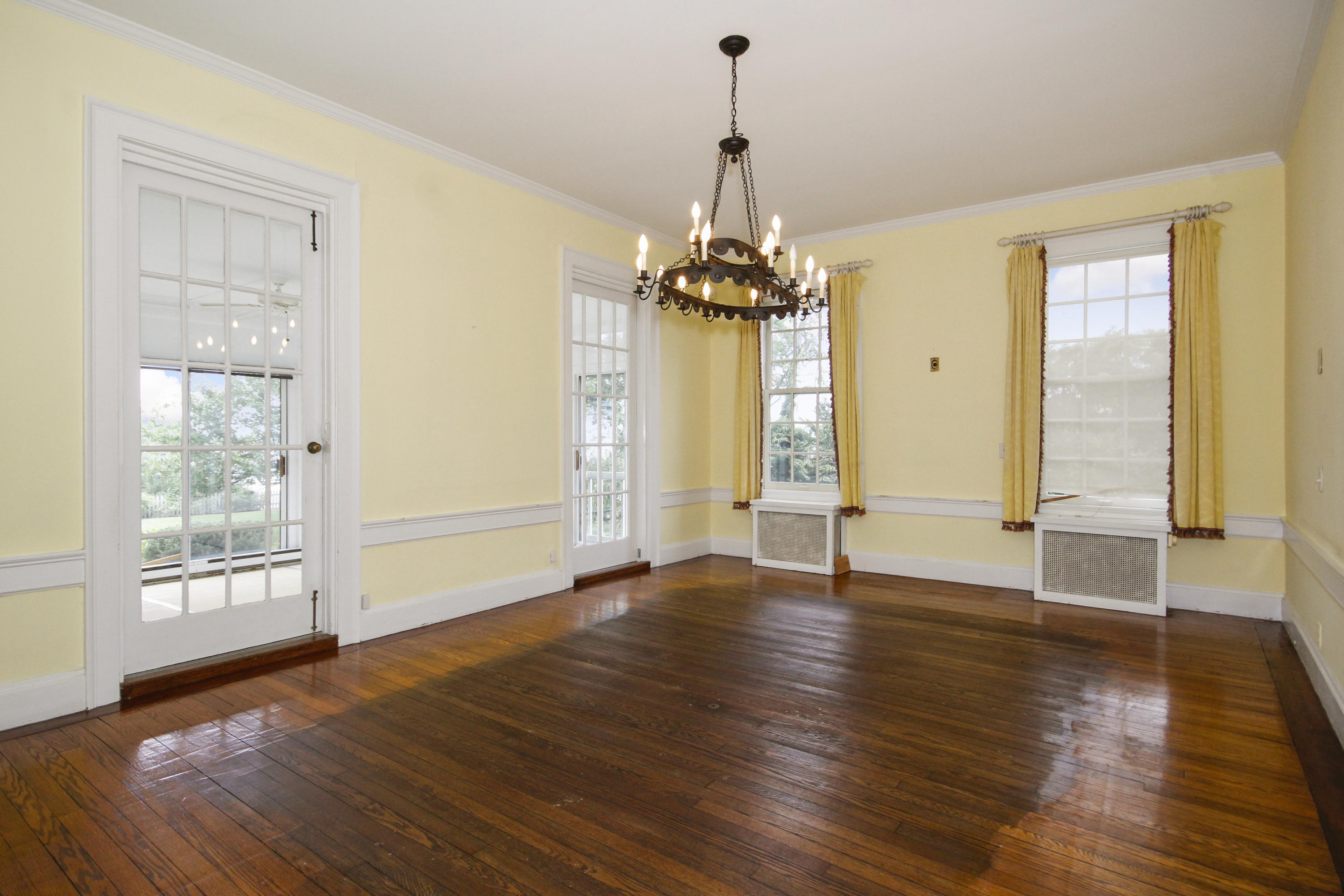 237 Long Neck Point Road Darien, CT 06820 - Photo 9 of 38 a view of an empty room with wooden floor and a window