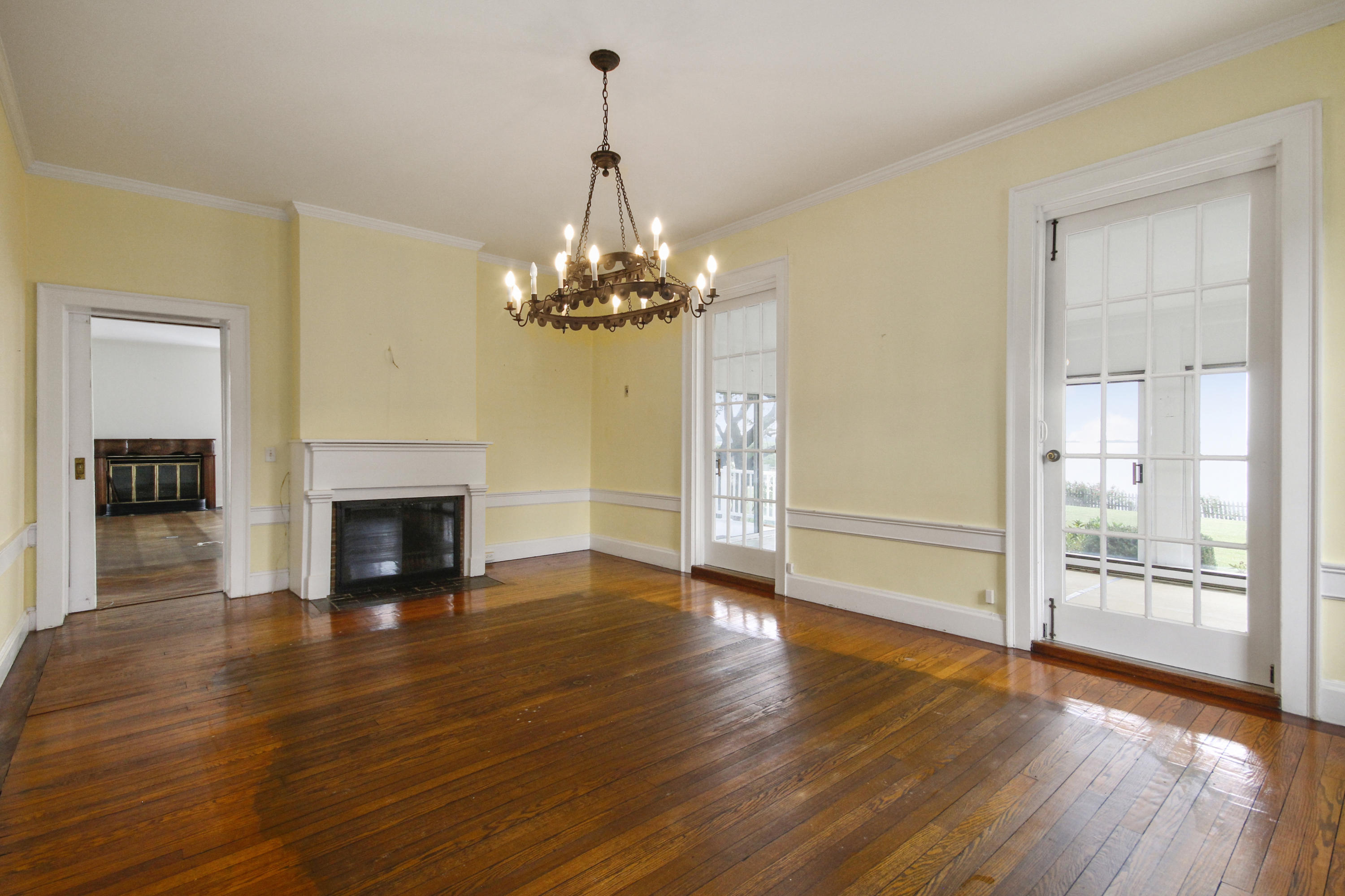 237 Long Neck Point Road Darien, CT 06820 - Photo 10 of 38 a view of an empty room with wooden floor fireplace and a window